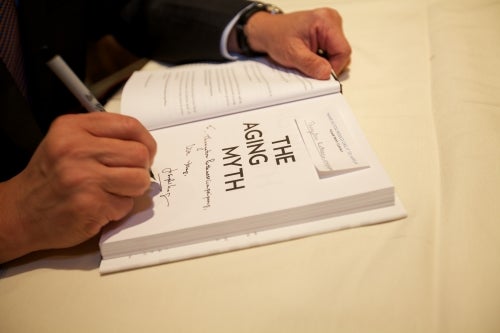 Joe Chang signing a book